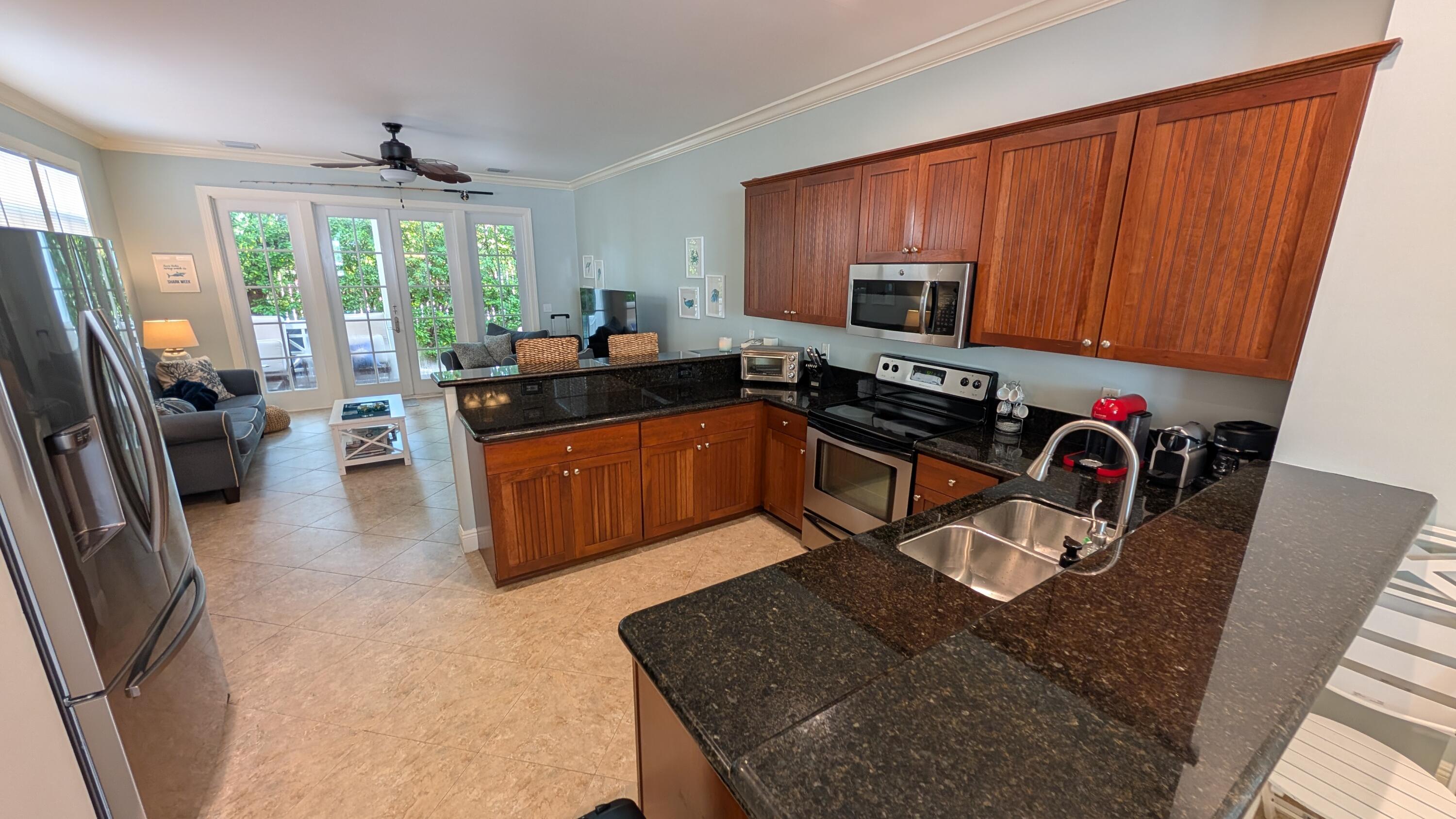 104 Anglers Way Islamorada, FL 33036 - Photo 13 of 18 a kitchen with stainless steel appliances granite countertop a sink stove and refrigerator