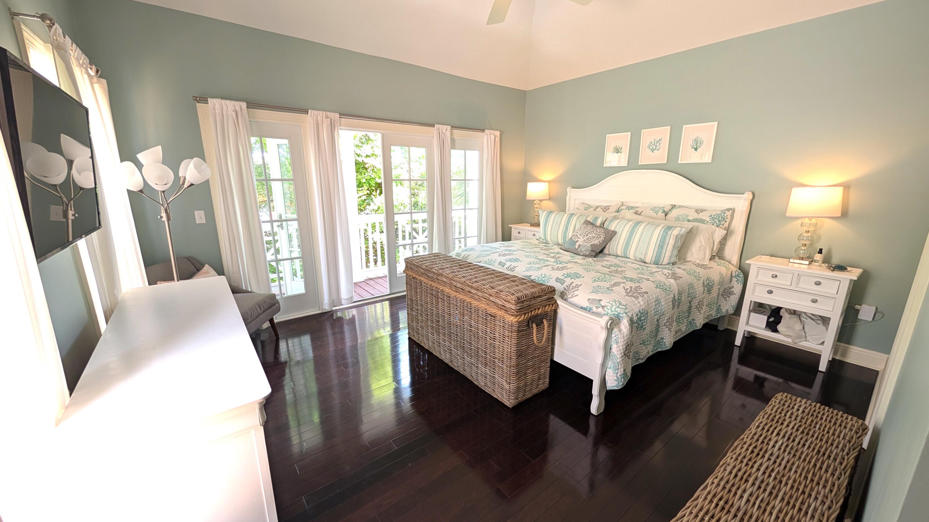 104 Anglers Way Islamorada, FL 33036 - Photo 14 of 18 a bedroom with a bed a couch and a large window