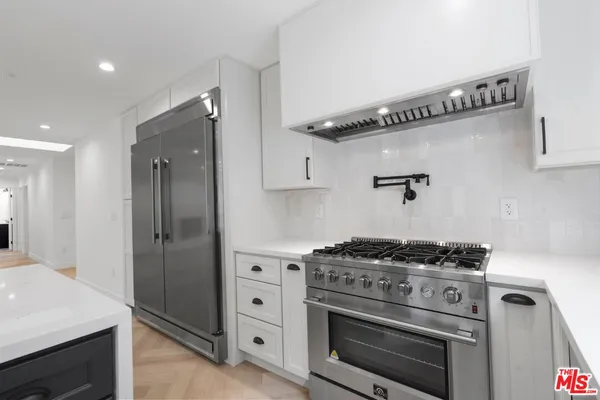 a kitchen with a stove and a refrigerator