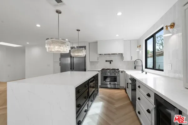 a kitchen with a stove and a sink