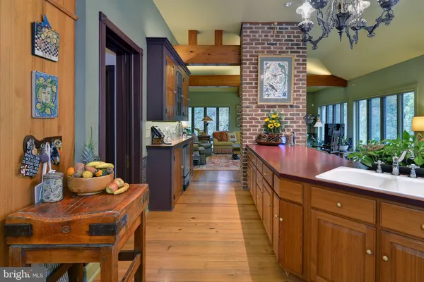 an aerial view of a house with a yard and large trees