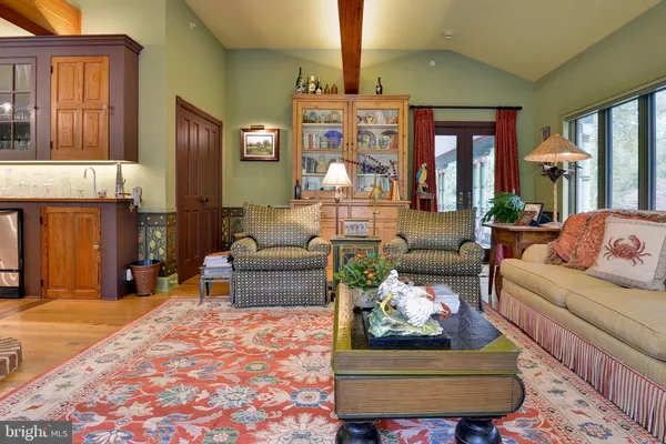 a dining room with furniture and a floor to ceiling window