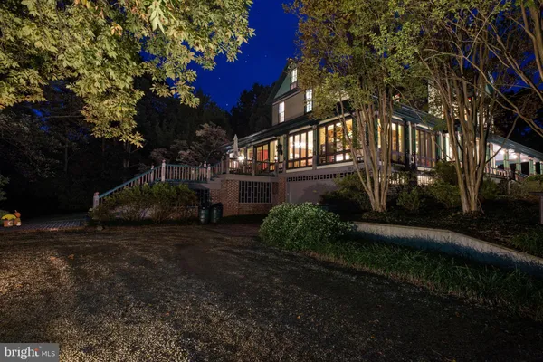 a living room with furniture a chandelier and a fireplace