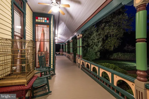 a living room with furniture a chandelier and a dining table