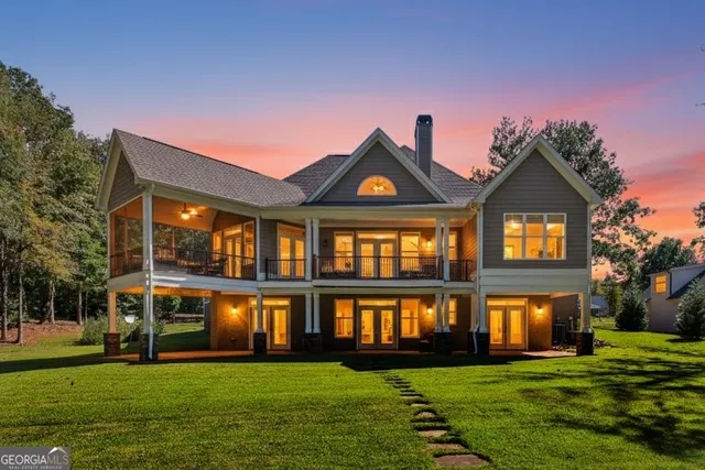a front view of a house with a yard and outdoor seating