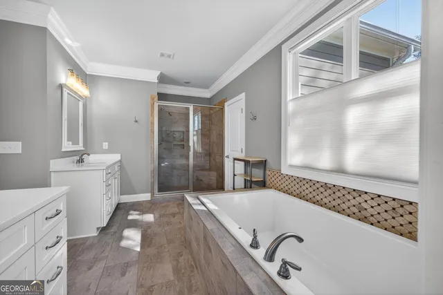 a bedroom with a bed and a flat tv screen on the dresser