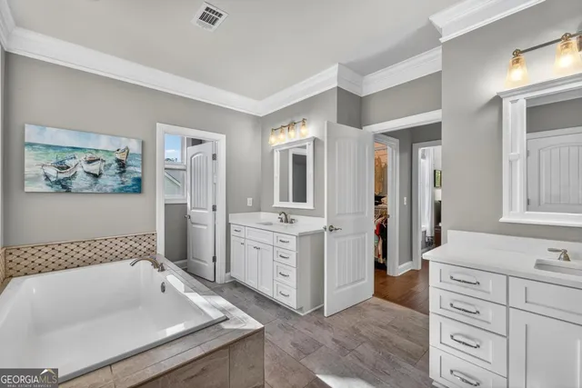 a view of a hallway with wooden floor and closet