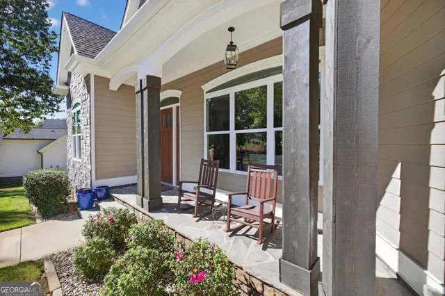 an aerial view of a house with a yard and lake view