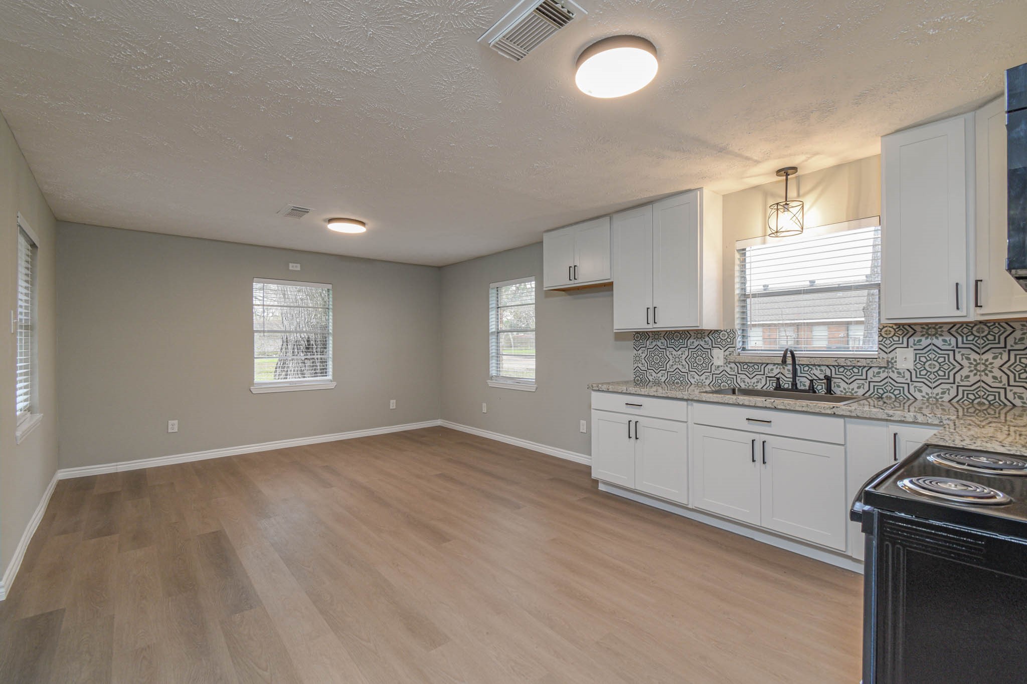 2834 Pansy Street Pasadena, TX 77503 - Photo 11 of 35 a kitchen with granite countertop a stove sink and cabinets