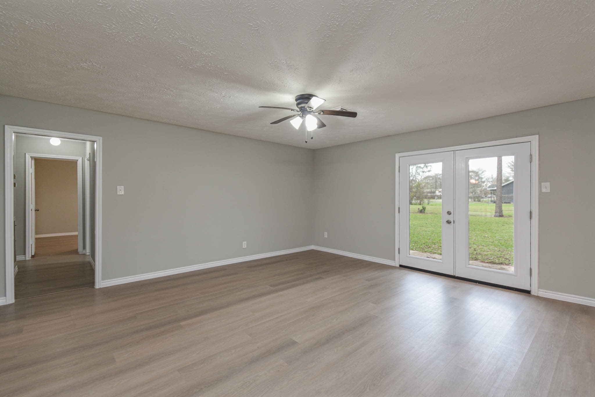 2834 Pansy Street Pasadena, TX 77503 - Photo 14 of 35 a view of an empty room with a window and wooden floor