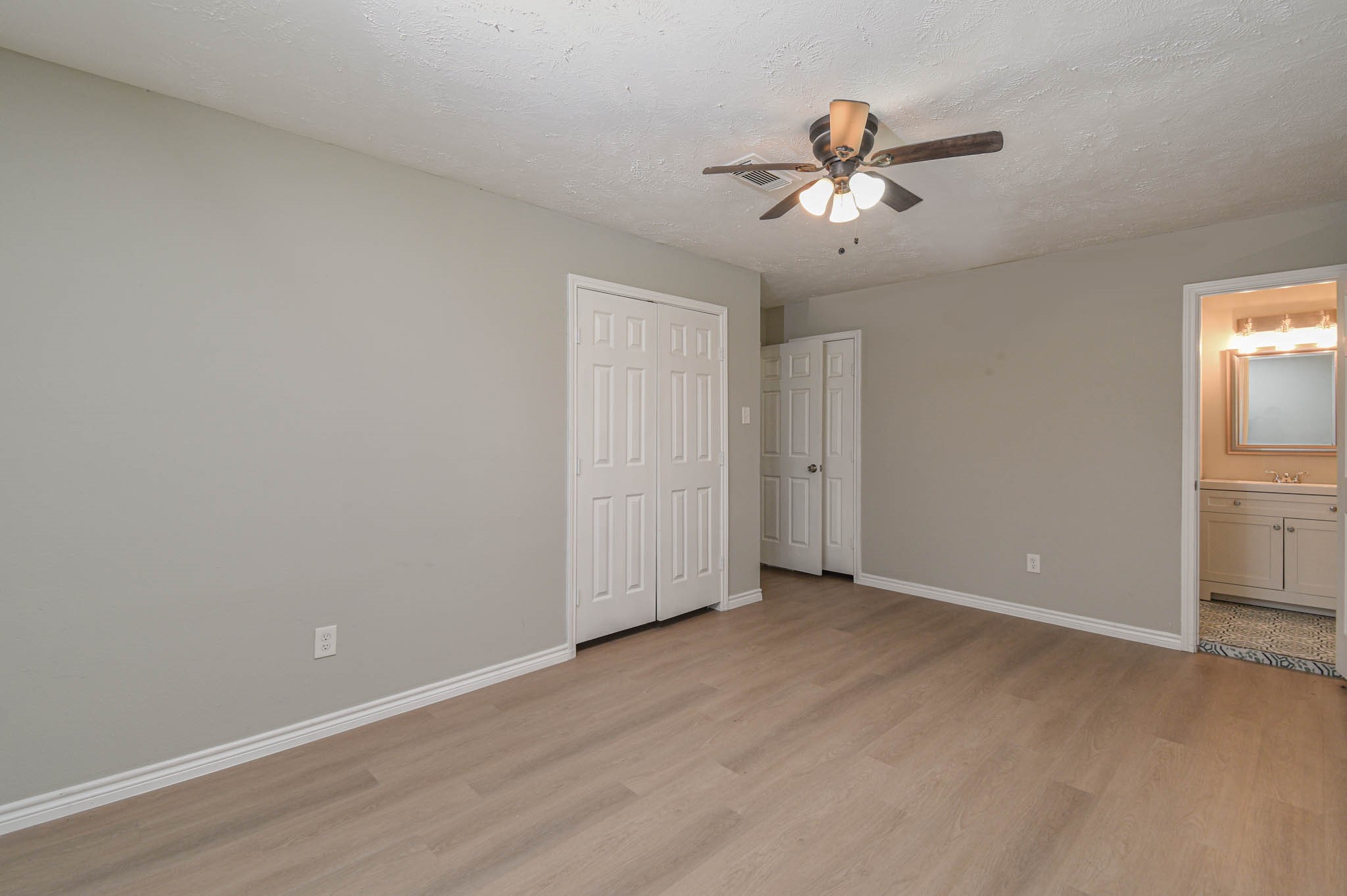 2834 Pansy Street Pasadena, TX 77503 - Photo 17 of 35 a view of a room with a ceiling fan and wooden floor