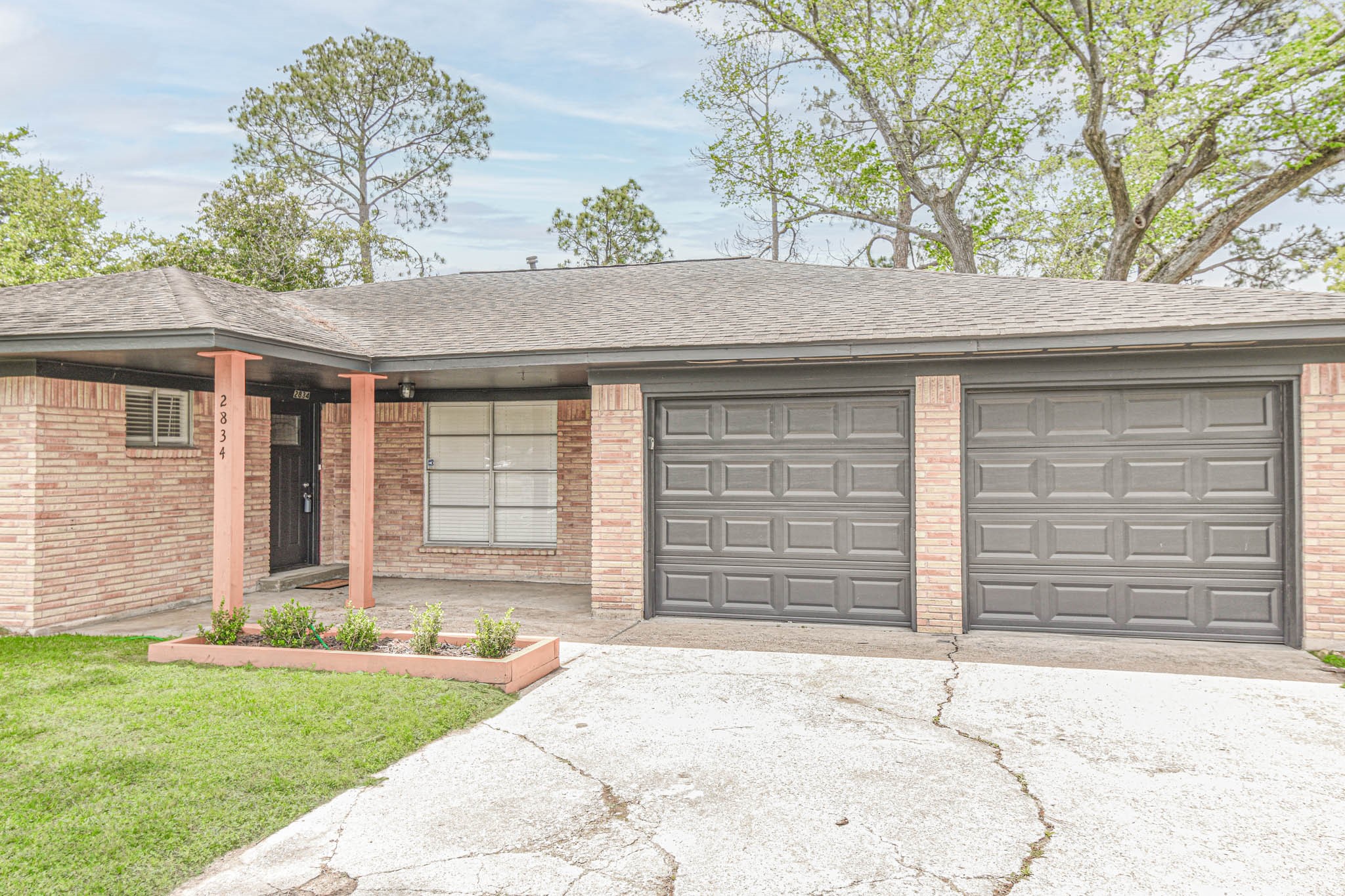 2834 Pansy Street Pasadena, TX 77503 - Photo 2 of 35 a front view of a house with a yard and garage