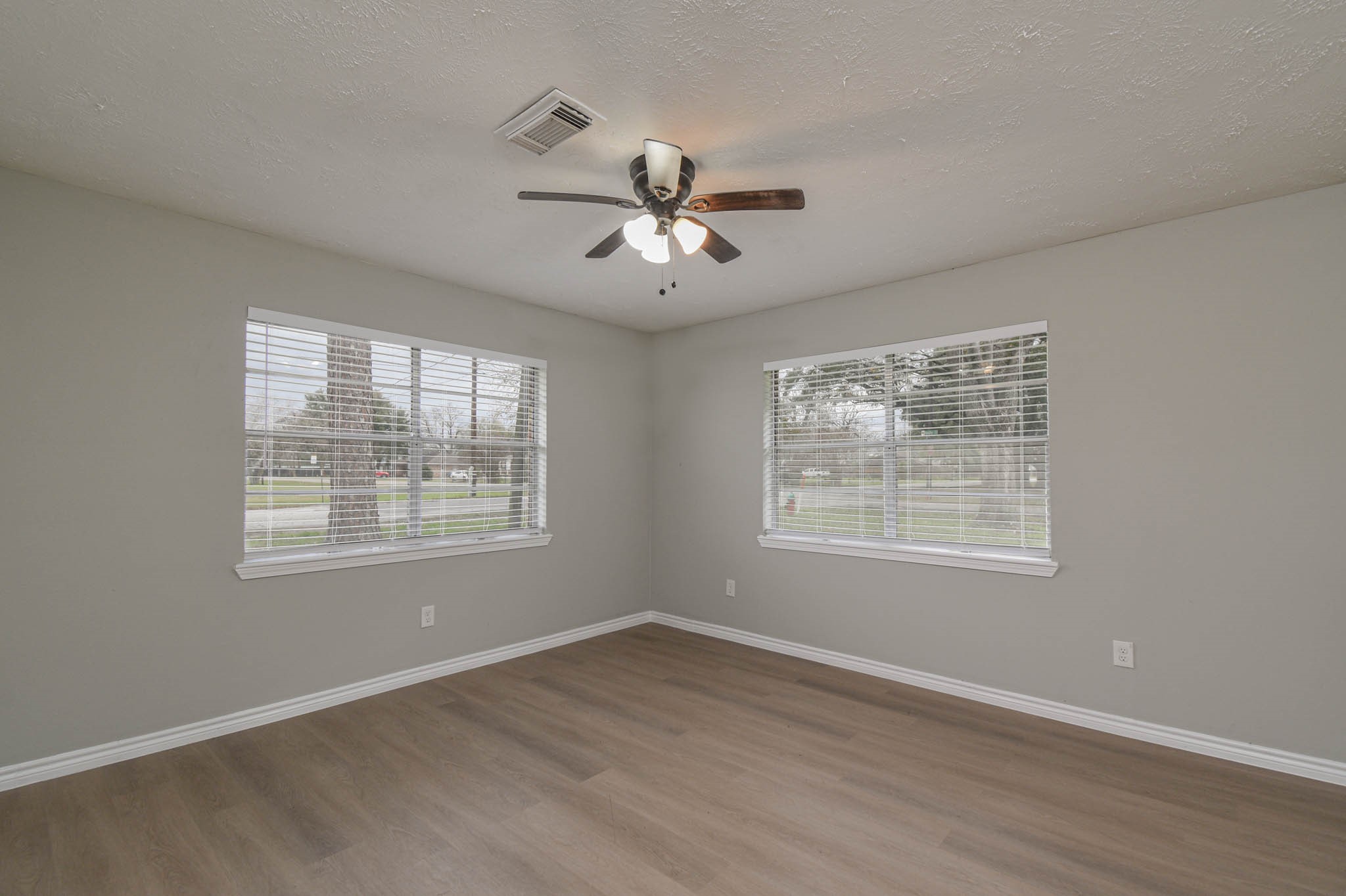 2834 Pansy Street Pasadena, TX 77503 - Photo 18 of 35 a view of an empty room with a window and wooden floor