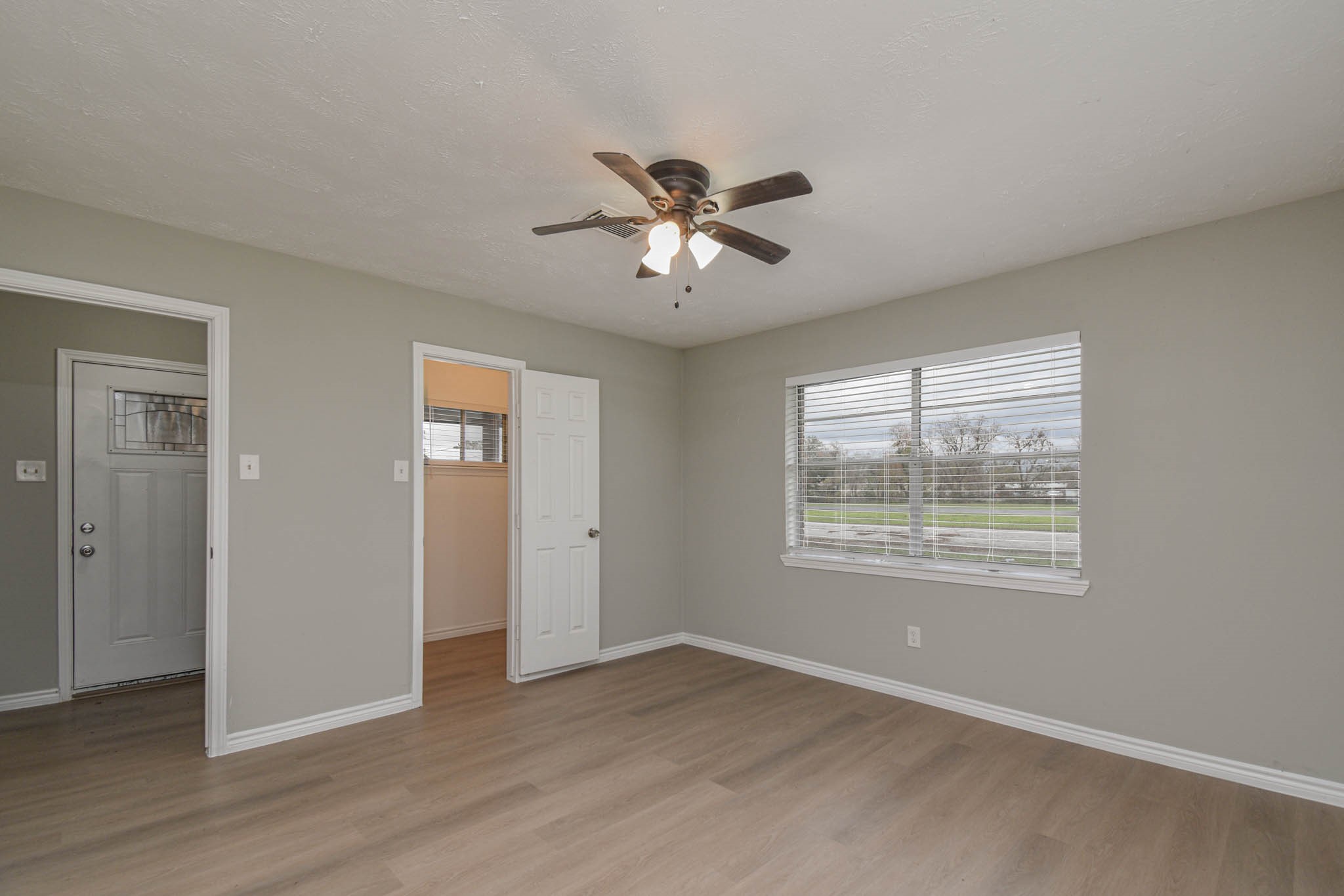 2834 Pansy Street Pasadena, TX 77503 - Photo 20 of 35 a view of an empty room with a window and wooden floor