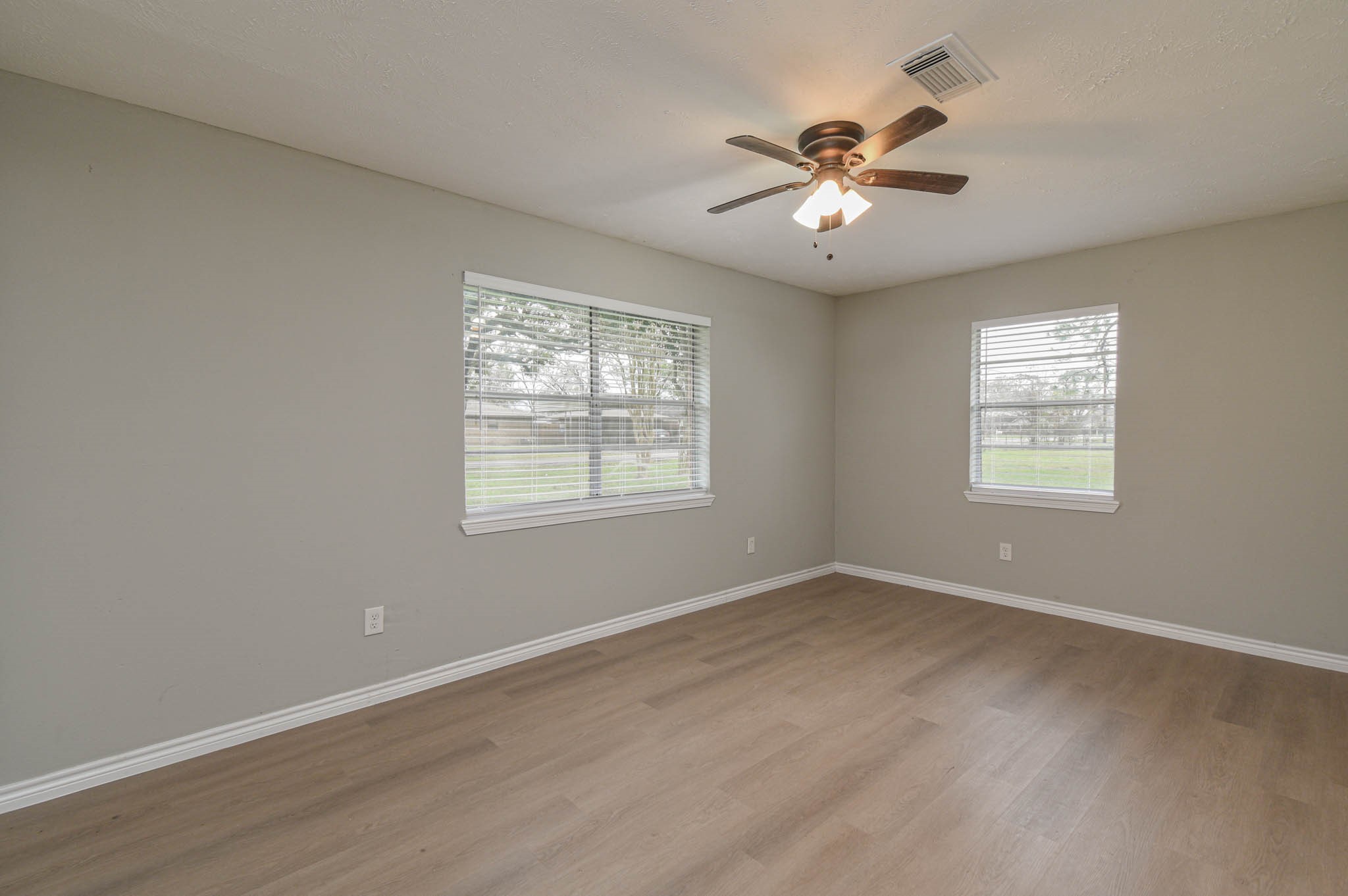 2834 Pansy Street Pasadena, TX 77503 - Photo 21 of 35 a view of an empty room with wooden floor and a window