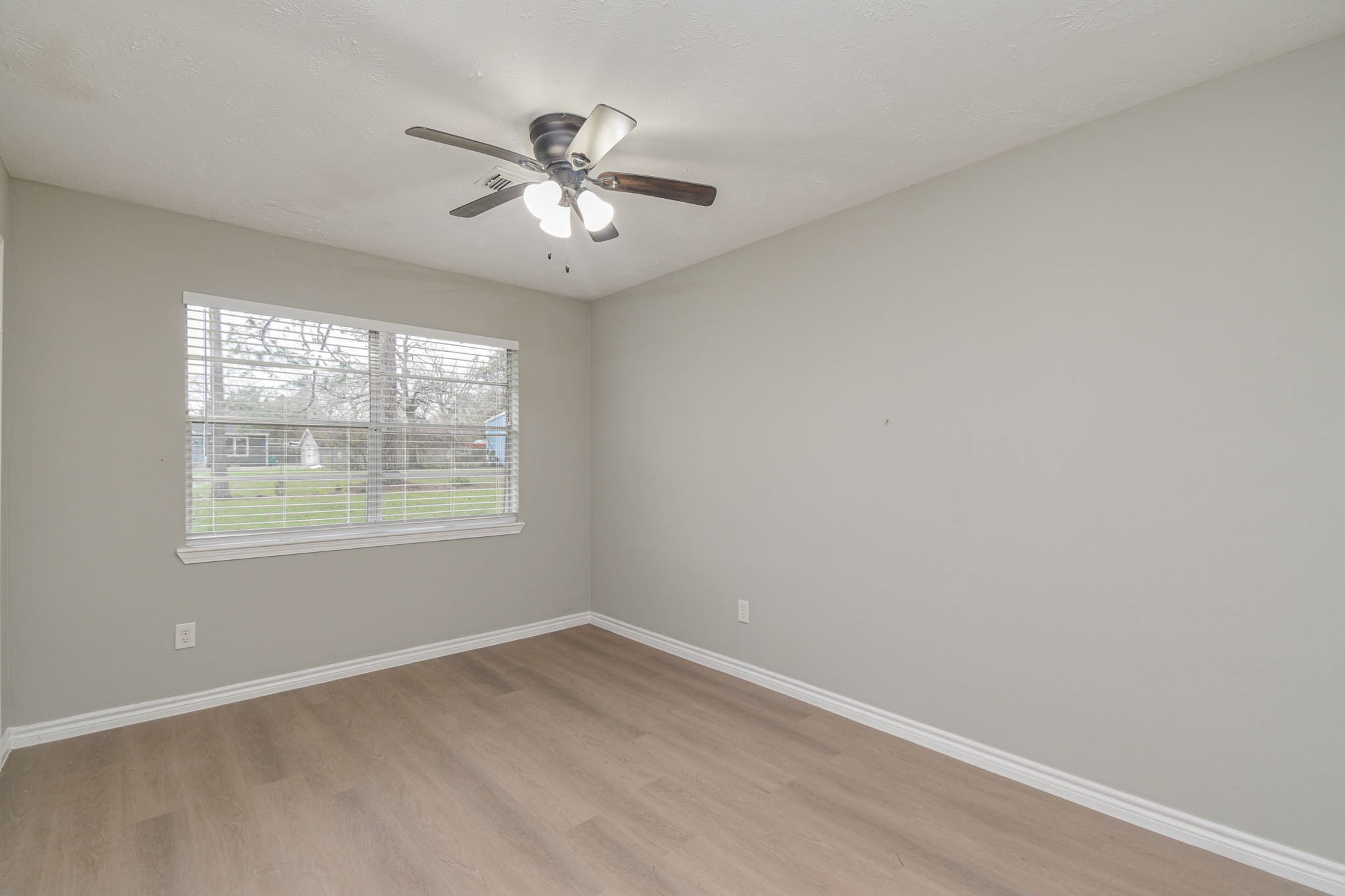 2834 Pansy Street Pasadena, TX 77503 - Photo 26 of 35 an empty room with wooden floor fan and windows