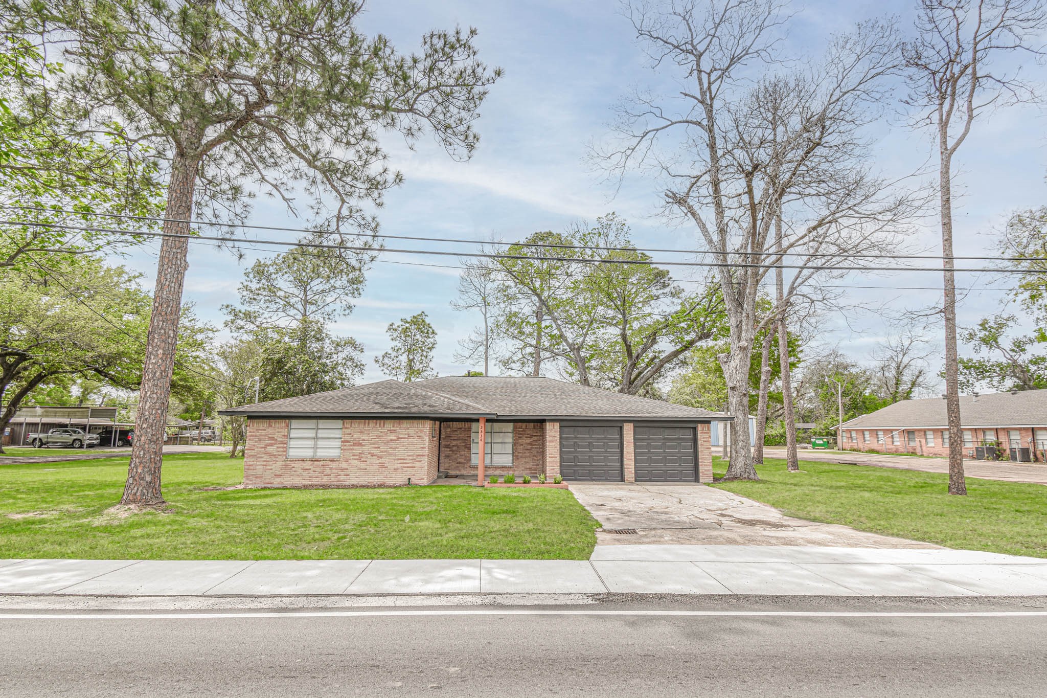2834 Pansy Street Pasadena, TX 77503 - Photo 31 of 35 a view of a brick house next to a yard with large trees