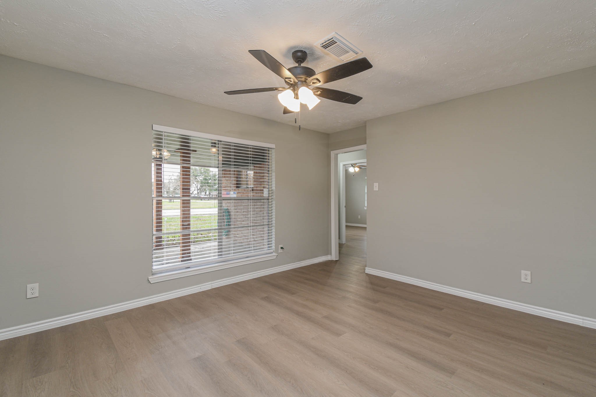2834 Pansy Street Pasadena, TX 77503 - Photo 5 of 35 an empty room with wooden floor fan and windows
