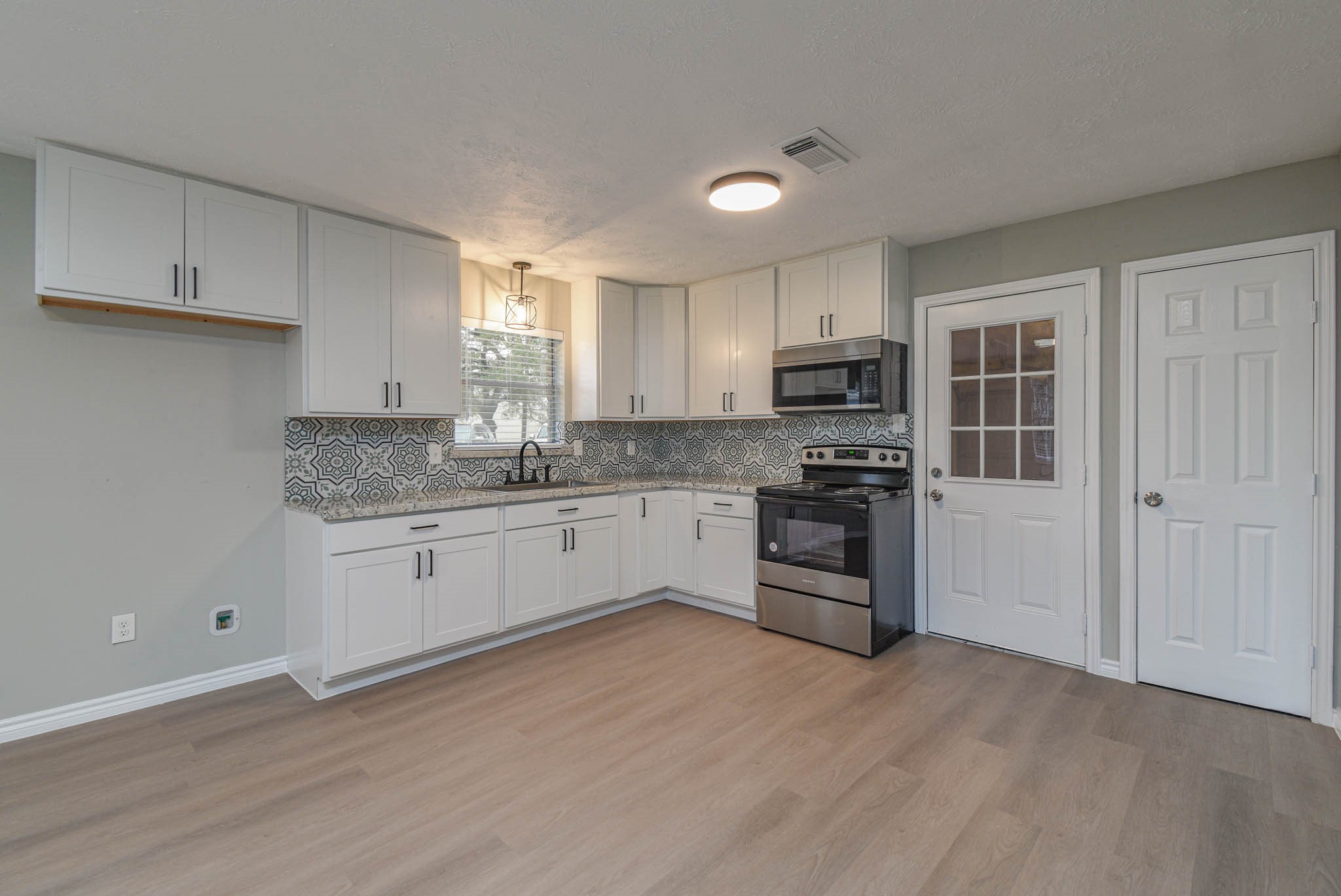 2834 Pansy Street Pasadena, TX 77503 - Photo 8 of 35 a kitchen with granite countertop a refrigerator and a stove top oven