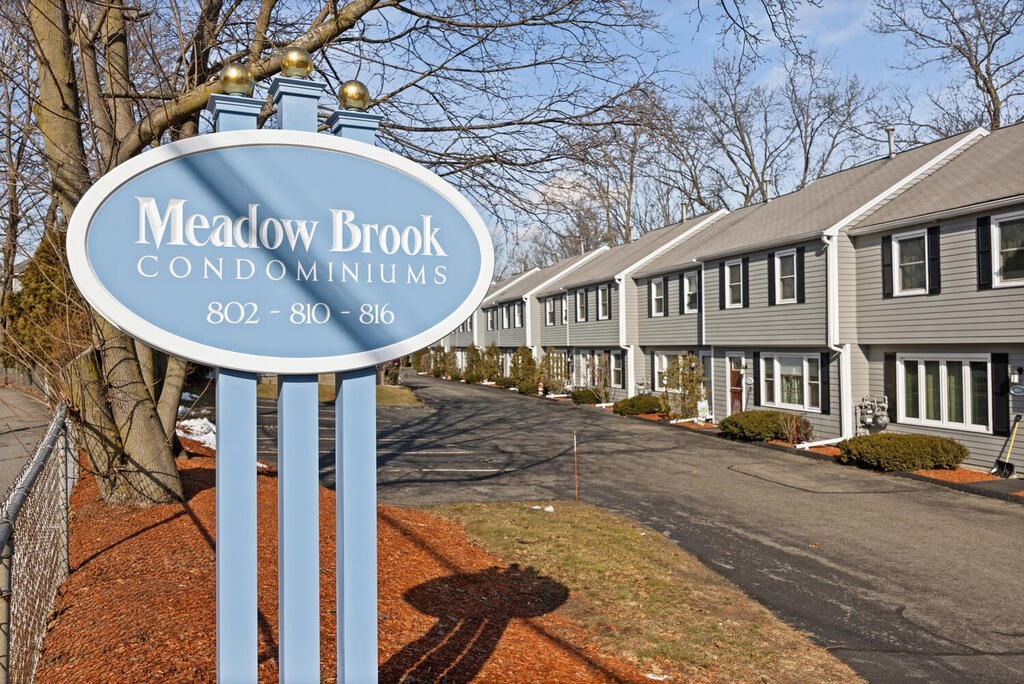 802 Lawrence Street, Unit D Lowell, MA 01852 - Photo 1 of 26 a sign on a pole on a street