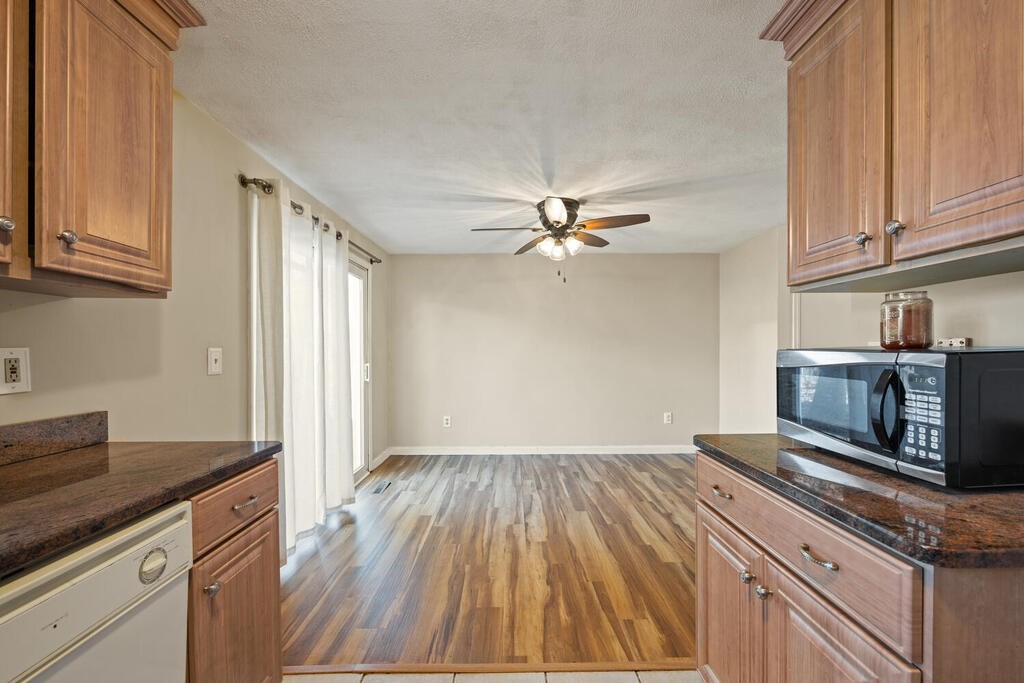 802 Lawrence Street, Unit D Lowell, MA 01852 - Photo 11 of 26 a kitchen with granite countertop stainless steel appliances a stove top oven cabinets a sink and a counter space
