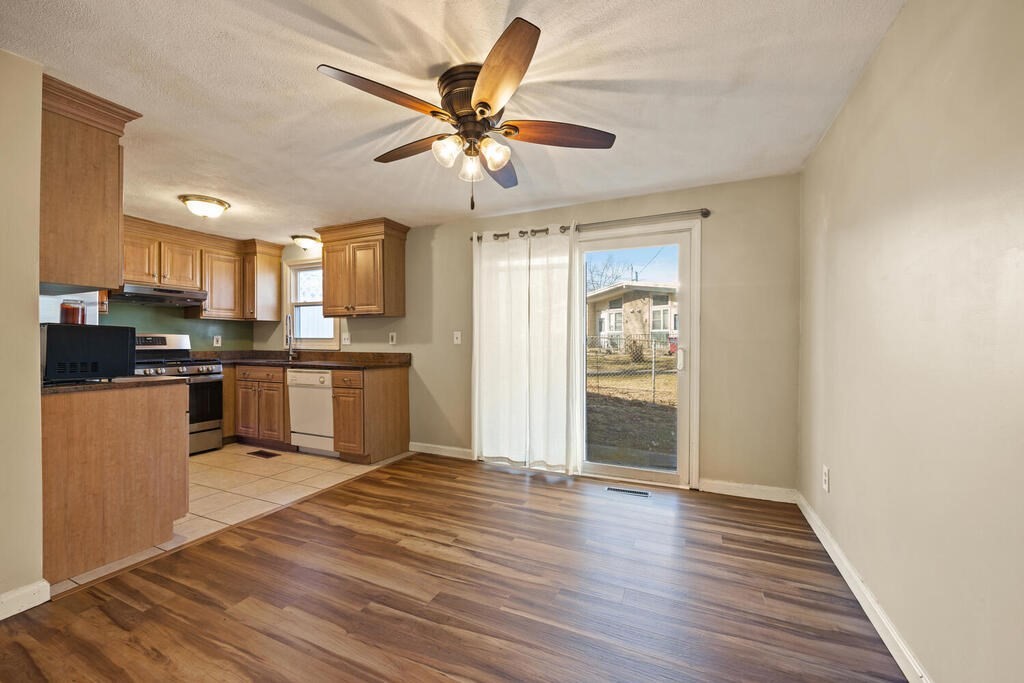 802 Lawrence Street, Unit D Lowell, MA 01852 - Photo 14 of 26 a open kitchen with wooden floor and stainless steel appliances