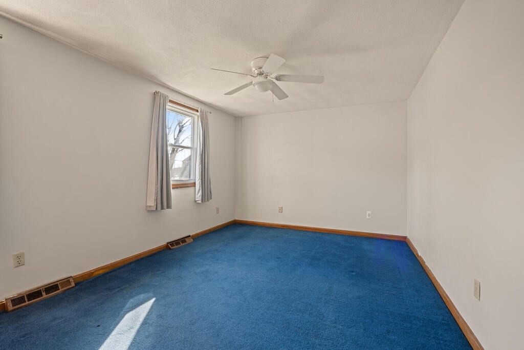 802 Lawrence Street, Unit D Lowell, MA 01852 - Photo 16 of 26 an empty room with windows and fan