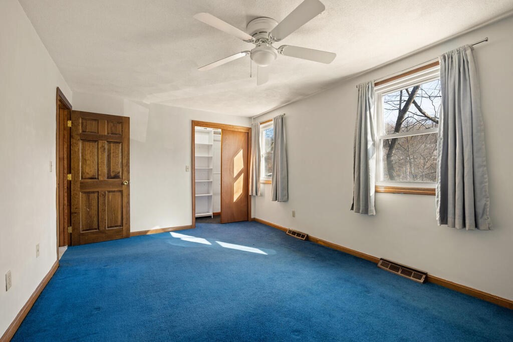 802 Lawrence Street, Unit D Lowell, MA 01852 - Photo 17 of 26 an empty room with windows and closet