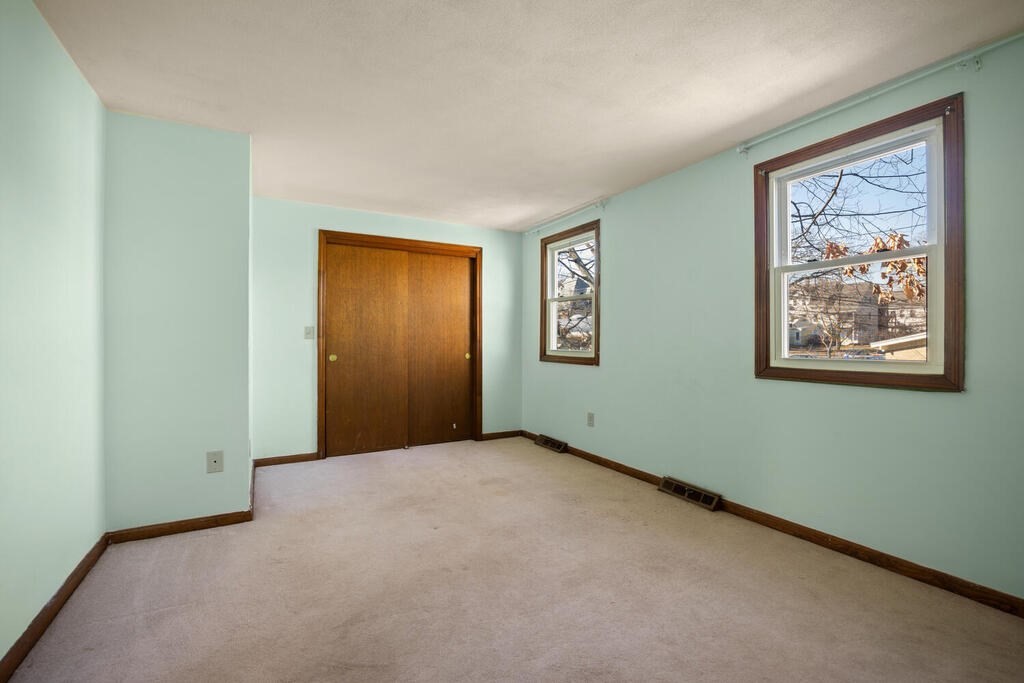 802 Lawrence Street, Unit D Lowell, MA 01852 - Photo 18 of 26 an empty room with windows