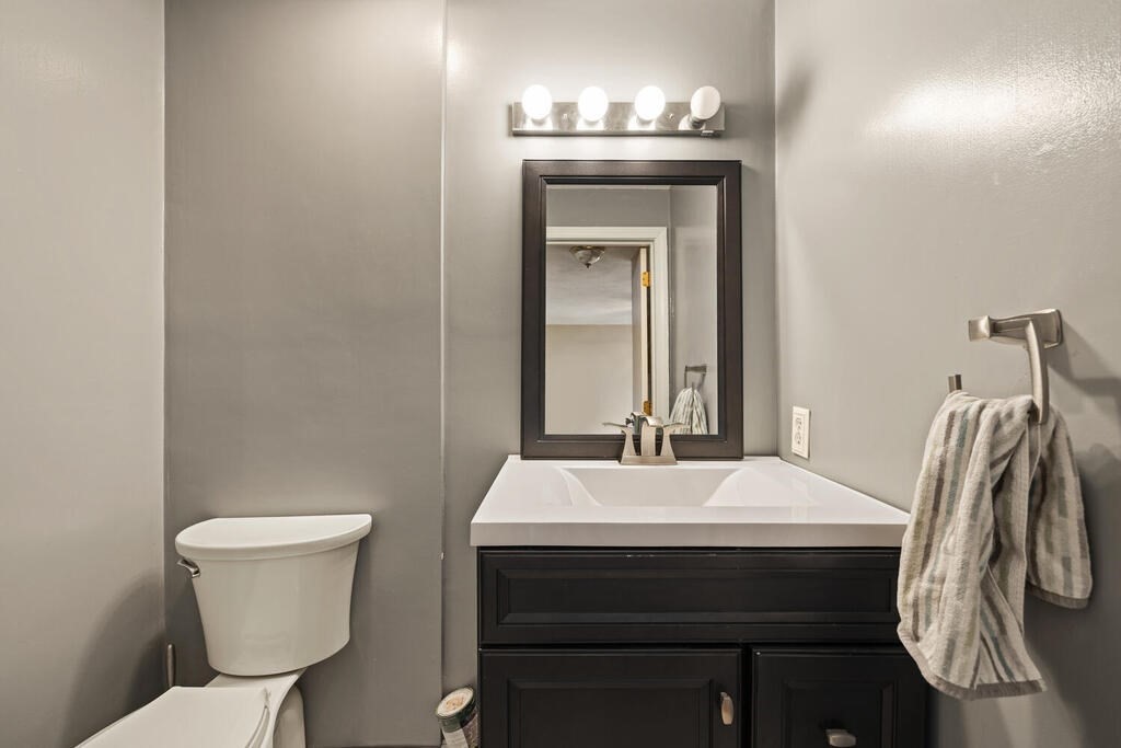 802 Lawrence Street, Unit D Lowell, MA 01852 - Photo 20 of 26 a bathroom with a sink a toilet and mirror
