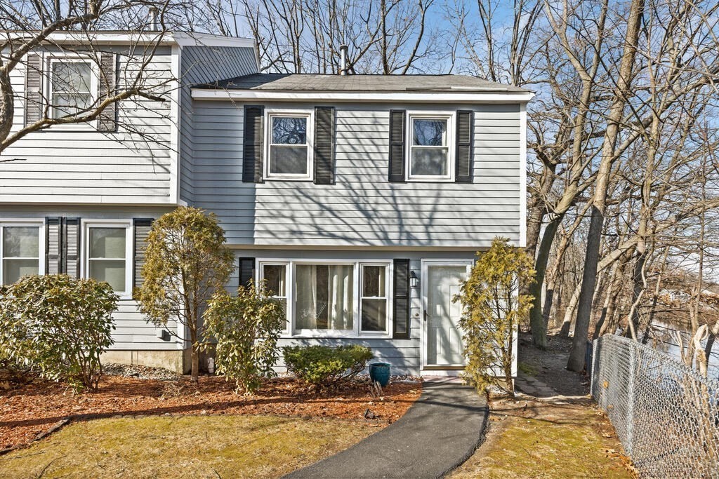 802 Lawrence Street, Unit D Lowell, MA 01852 - Photo 2 of 26 front view of a house with a yard
