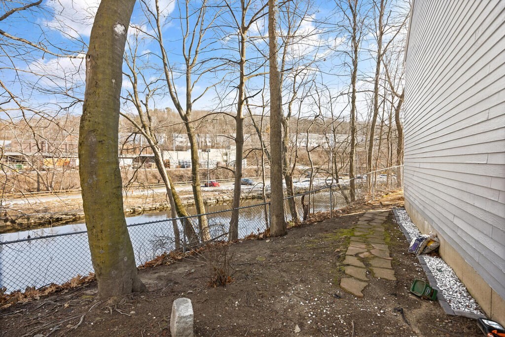 802 Lawrence Street, Unit D Lowell, MA 01852 - Photo 26 of 26 a view of a yard with an outdoor space