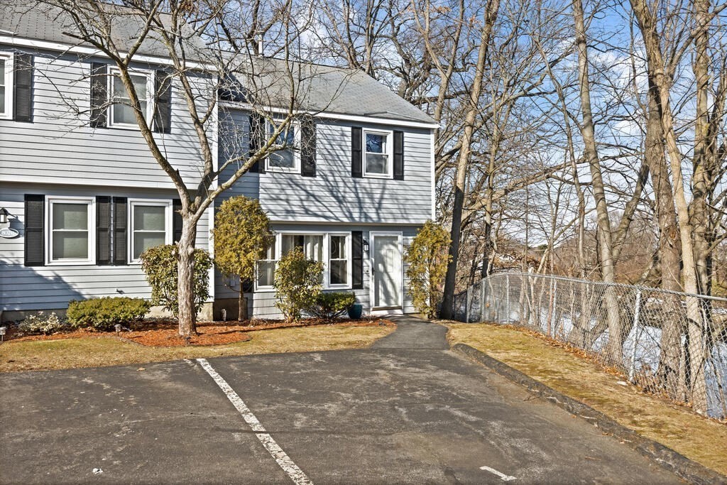 802 Lawrence Street, Unit D Lowell, MA 01852 - Photo 3 of 26 a front view of a house with a yard