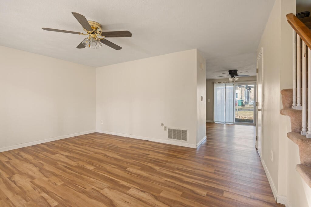802 Lawrence Street, Unit D Lowell, MA 01852 - Photo 6 of 26 a view of a livingroom with wooden floor and a ceiling fan