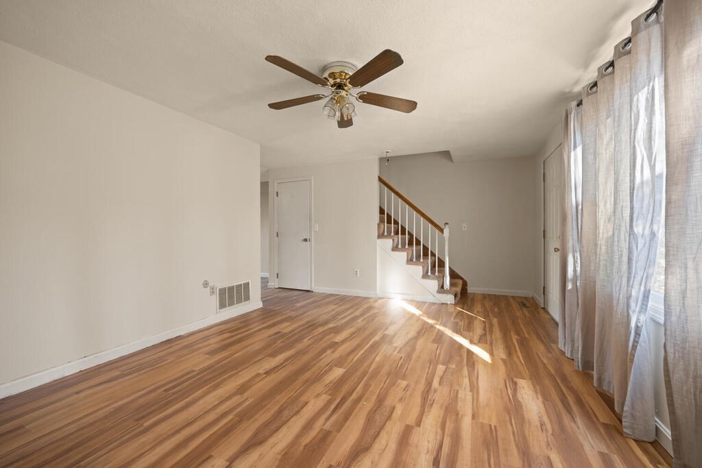 802 Lawrence Street, Unit D Lowell, MA 01852 - Photo 7 of 26 a view of empty room with wooden floor and fan