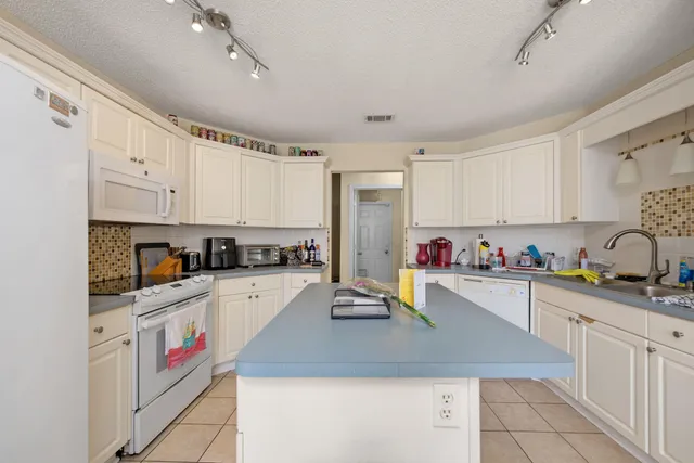 a kitchen with cabinets a sink and appliances