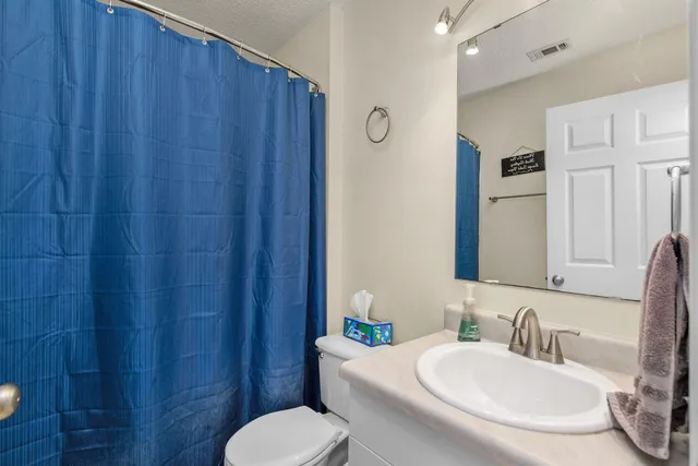 a bathroom with a toilet a sink and a mirror