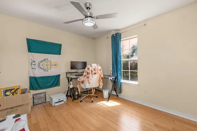a view of a workspace with furniture and a window