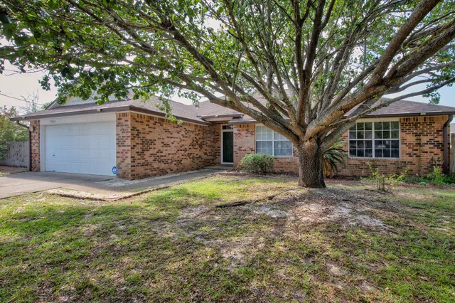 a view of a house with a yard and garage