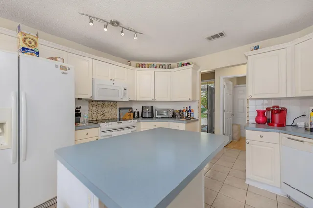 a view of a kitchen with sink and microwave