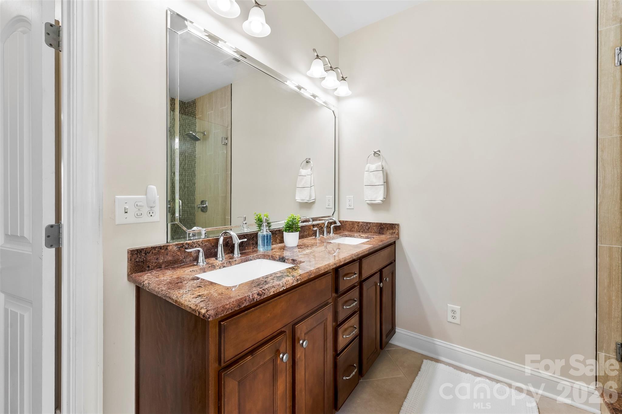 7574 Manakin Place Fort Mill, SC 29707 - Photo 20 of 40 a bathroom with a granite countertop sink and a mirror