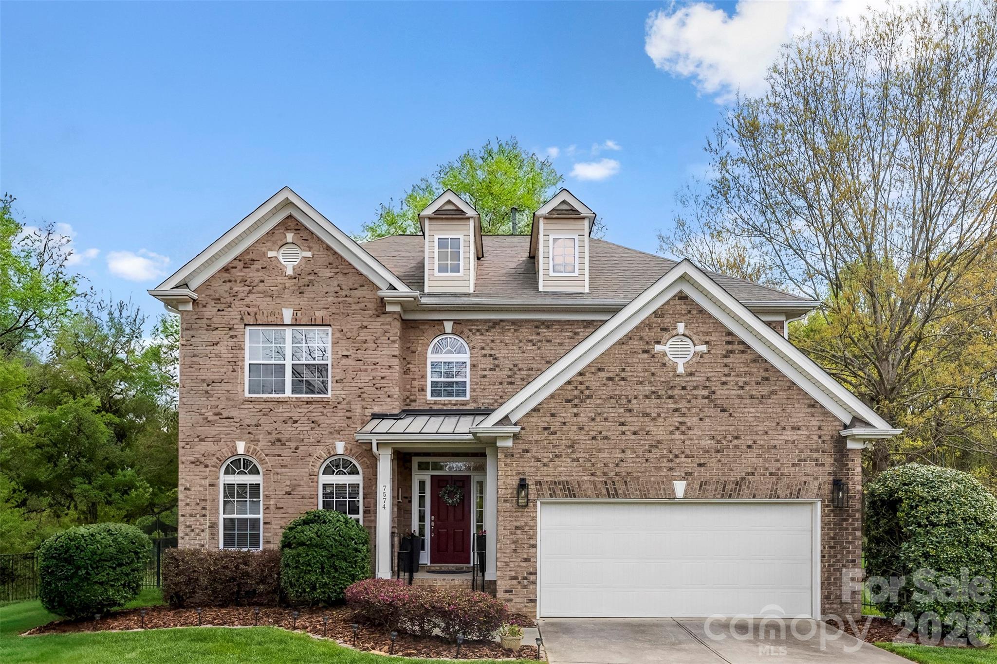 7574 Manakin Place Fort Mill, SC 29707 - Photo 2 of 40 a front view of a house with garden