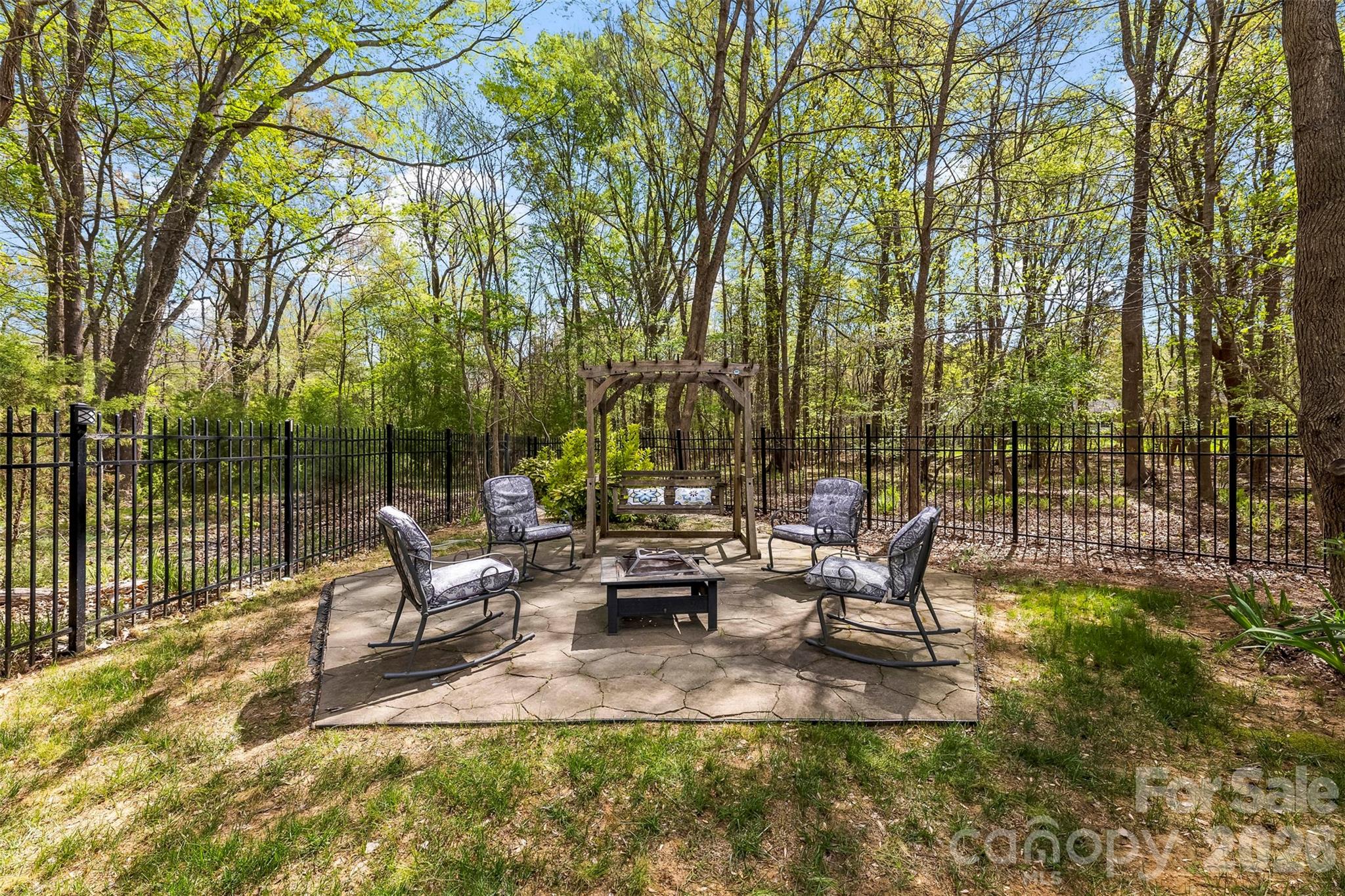 7574 Manakin Place Fort Mill, SC 29707 - Photo 33 of 40 a view of a patio with table and chairs potted plants and large tree