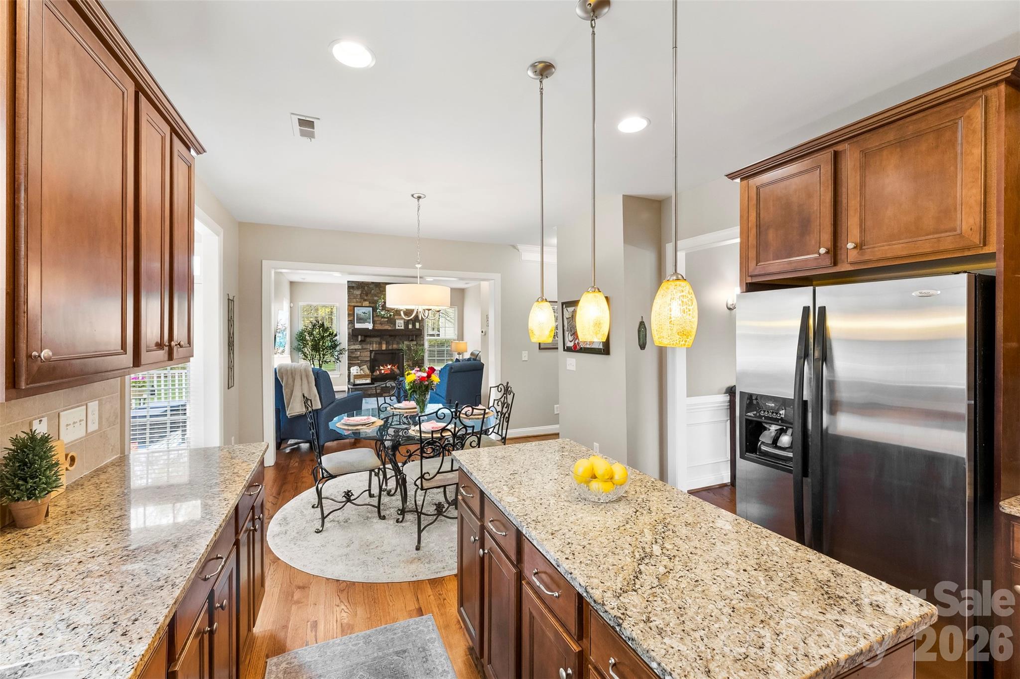 7574 Manakin Place Fort Mill, SC 29707 - Photo 10 of 40 a kitchen with granite countertop stainless steel appliances a sink refrigerator and microwave