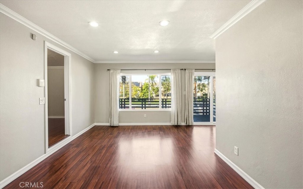 1200 West Lambert Road, Unit 24 La Habra, CA 90631 - Photo 11 of 38 a view of an empty room with wooden floor and a window