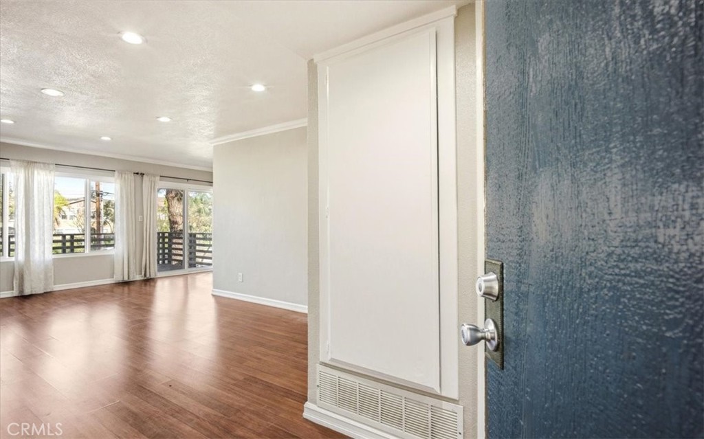 1200 West Lambert Road, Unit 24 La Habra, CA 90631 - Photo 8 of 38 an empty room with wooden floor and windows