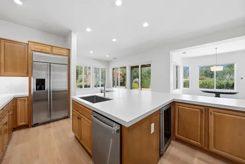 a kitchen with a sink stove and refrigerator