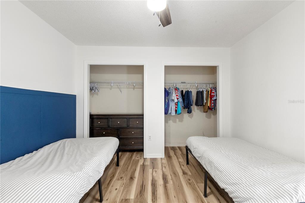 9917 Nelson Road Dade City, FL 33525 - Photo 33 of 40 a bedroom with a bed and a chandelier