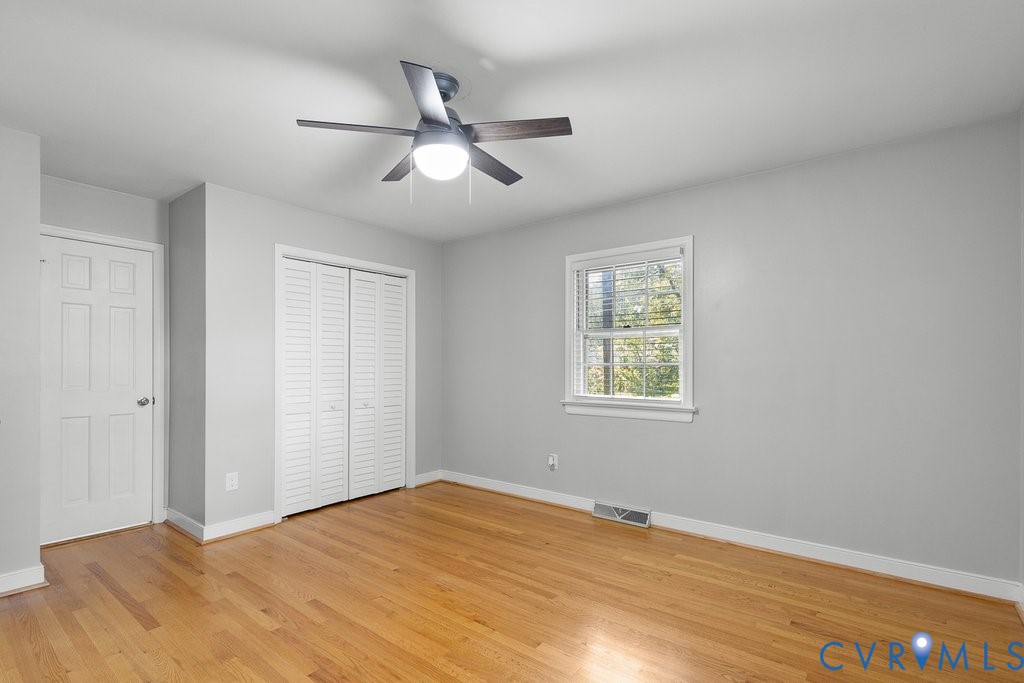 11440 Rochelle Road Chester, VA 23831 - Photo 20 of 31 a view of empty room with wooden floor and fan