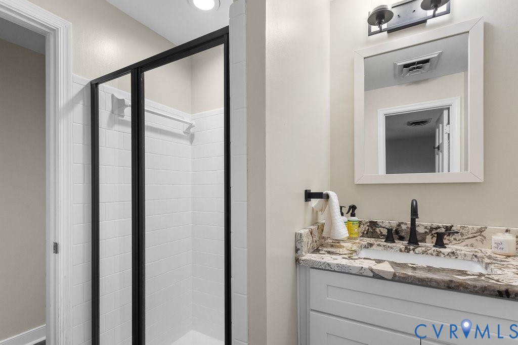 11440 Rochelle Road Chester, VA 23831 - Photo 21 of 31 a bathroom with a granite countertop sink and a mirror
